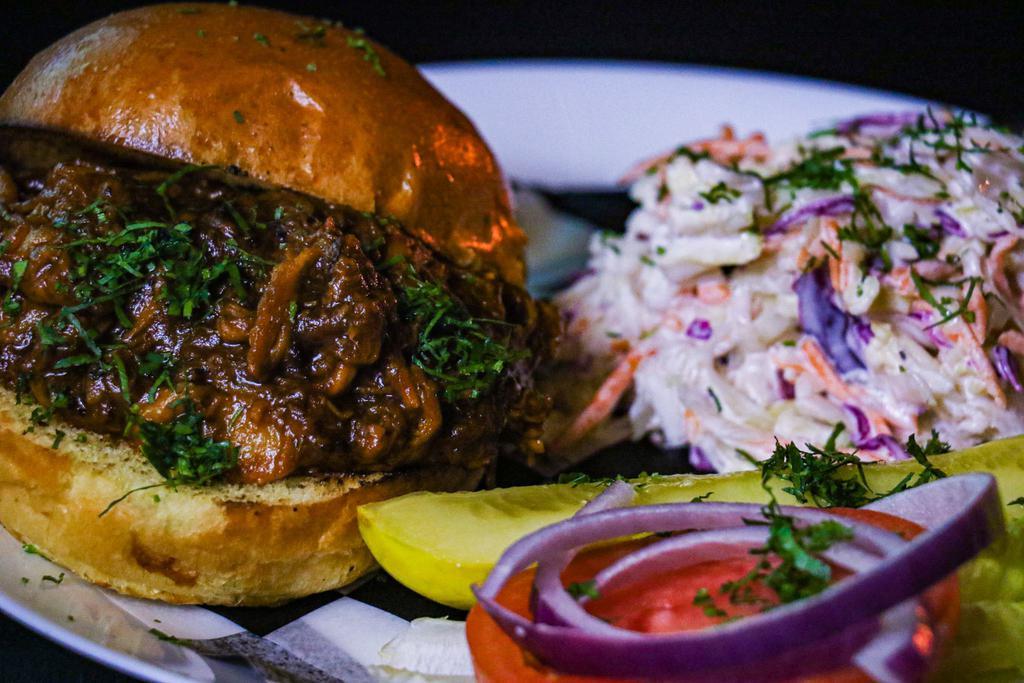 Pulled Pork Sandwich · Loaded slow cooked pulled pork on a brioche bun served with hour homemade coleslaw
