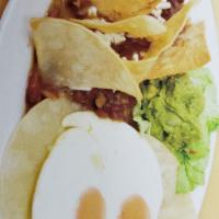 11. Huevos Rancheros · 2 eggs on a tortilla with beans and guacamole.
