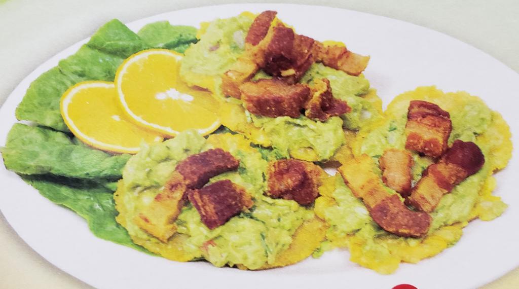 43. Tostones con Guacamole y Chicharron · Fried green plantains topped with guacamole and pork skin.