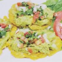 44. Tostones con Guacamole y Pico de Gallo · Fried green plantains topped with guacamole and fresh pico de gallo. Vegetarian.