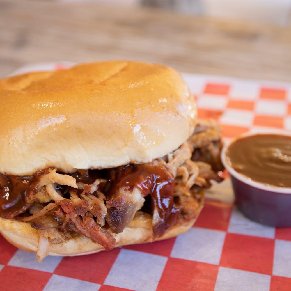 BBQ Sandwich on a Bun · Served with BBQ sauce, pickle and onions.