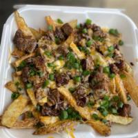 Loaded Cheesy Steak Fries · Steak and more steak over hand-cut french fries and shredded American cheese.