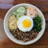 Bibimbap · The Korean Tradition at its best! 
A bowl of white rice with a protein of your choice, daiko...