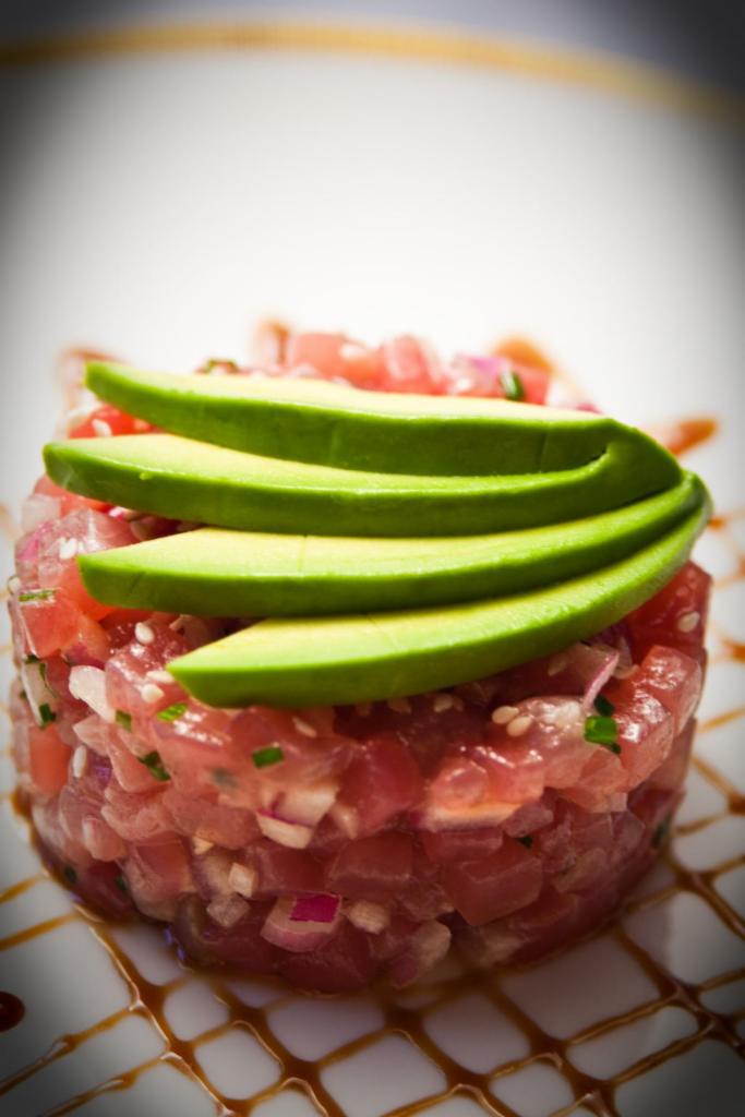 Tuna Tartar · Hand chopped tuna, avocado, crunch, masago, mixed with sweet sauce and spicy mayo.
