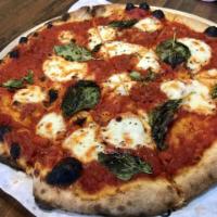 Classic Margherita Pizza · Classic red sauce, fresh mozzarella, extra virgin olive oil, oregano and fresh basil.