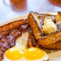 Continental Breakfast · 4 wedges of French toast with 2 eggs and choice of 2 bacon strips or 2 sausage links.