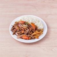 Lomo Saltado · Beef sauteed in soy sauce, onion, tomato served with french fries and rice.