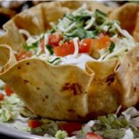 Taco Salad · A large fried flour tortilla shell stuffed with seasoned ground beef or spicy chicken topped...