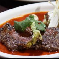 Aztec Ribeye · 10-oz. grilled ribeye served with guajillo, poblano, mashed potatoes, grilled Mexican onion ...