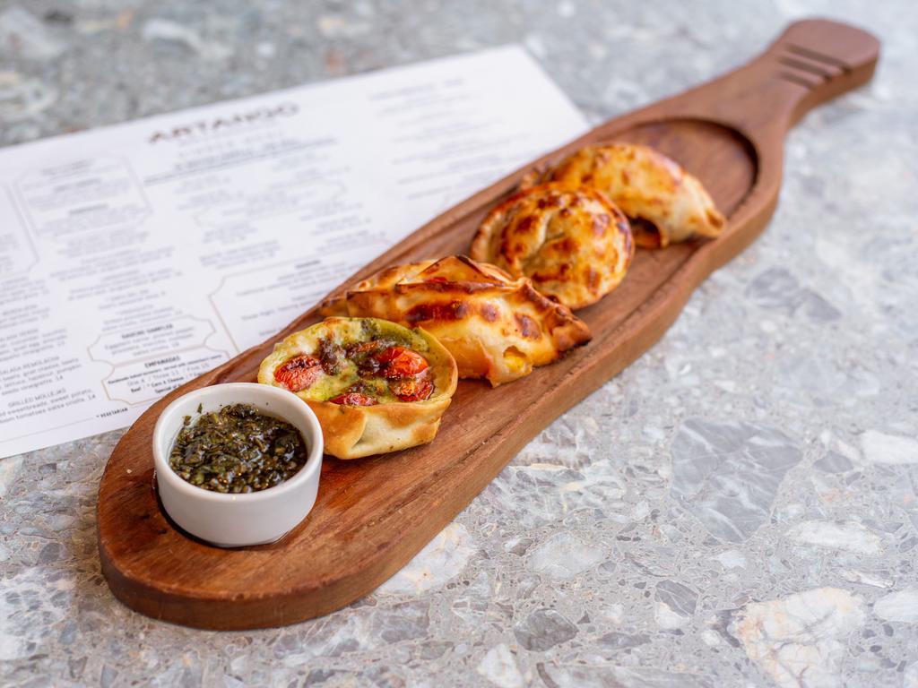 Beef Empanada · Handmade baked turnovers and served with chimichurri sauce.