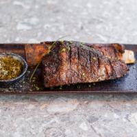 Asado de Tira · Slow-grilled short ribs. All beef is imported from Argentina, highest quality grass-fed blac...