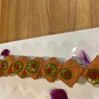 Spicy Blue Crab Roll · Spicy crab meat, tobiko, cucumber inside spicy tuna and jalapeño on top.
