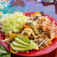 Nachos · Tortilla chips with choice of meat, topped with jalapenos, sour cream, beans, cheese, lettuc...