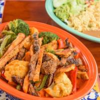 Fajitas · Chicken or beef fajitas mixed with vegetables, rice, beans and salad.