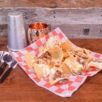 Miner's Nachos · A bed of thin crispy tortilla chips topped with grilled chicken, our house made green chili ...