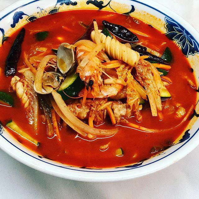 Jang Bong Spicy Noodle Soup · Pork, shrimp, squid, clams, mussels and vegetables simmered in a rich spicy chicken broth and then ladled over our noodles.