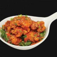 Rock Chicken · Tempura fried chicken in sweet and sour sauce. Served over a salad and topped with green oni...
