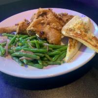 1/2 of a Fried Chicken · Pieces of fried chicken served with potato wedges and bread.