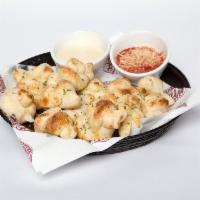 Garlic Bites · Fresh dough knots brushed with garlic butter, grated Parmesan cheese, Romano cheese. Served ...