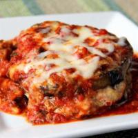 Eggplant Parmigiana · Breaded eggplant topped with mozzarella cheese and tomato sauce served with pasta.