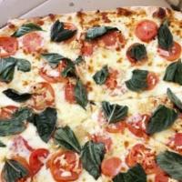 Marguerita Pizza · Olive oil with fresh basil, fresh garlic, and fresh tomatoes. 