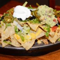 Supreme Nachos · Homemade tortilla chips, jalapeno, black olives, tomato, cheese, sour cream. Add meat and gu...