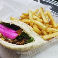 Chicken Shawarma Sandwich with Fries. · Thinly sliced chicken shawarma sandwich, pickles, salad and our signature garlic sauce. With...