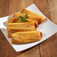 30. Tamale Plate · 2 tamales, stuffed with red chille pork, smothered with chile sauce and cheese served with l...