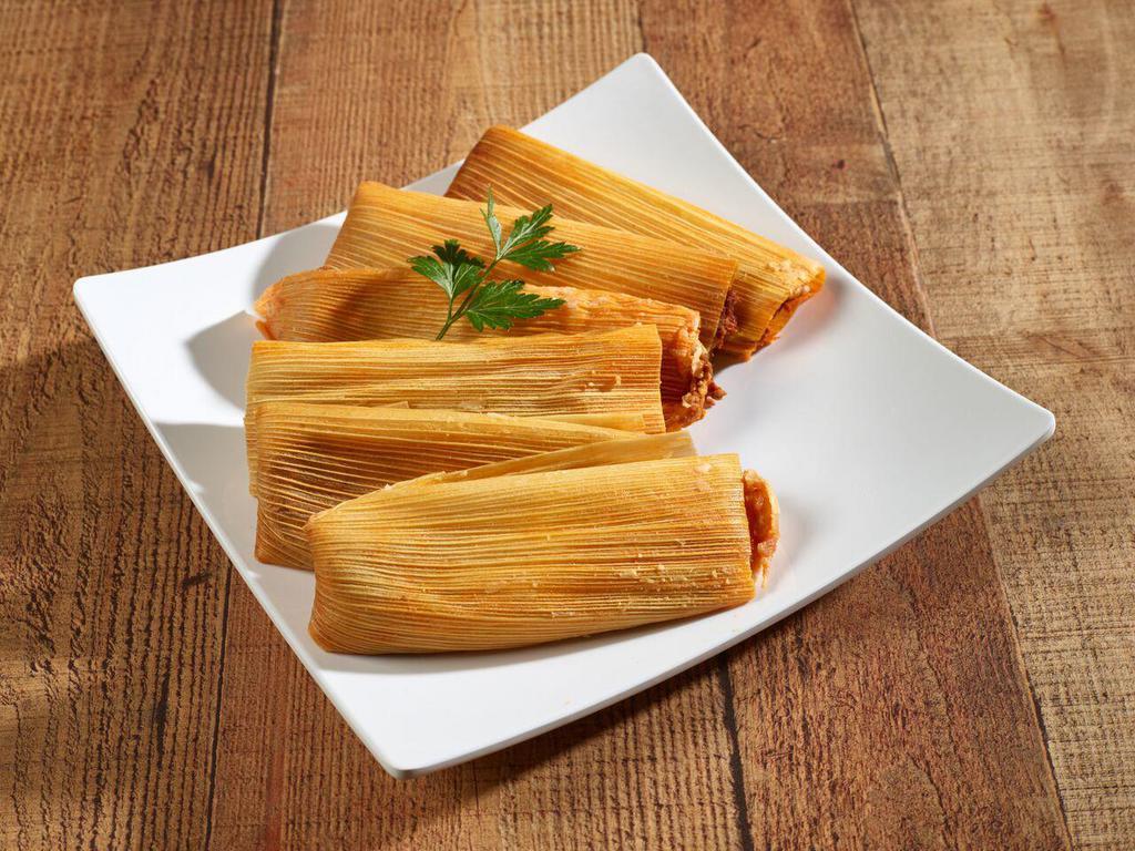 30. Tamale Plate · 2 tamales, stuffed with red chille pork, smothered with chile sauce and cheese served with lettuce and tomato.