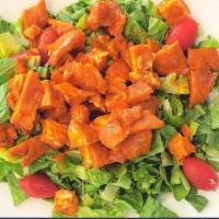 Buffalo Chicken Salad · Crispy chicken tenders smothered in mild wing sauce on a bed of romaine lettuce, tomatoes an...
