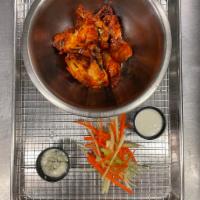 Wings · 6 confit, fried, and then grilled chicken wings tossed in a sauce of your choice. Served wit...