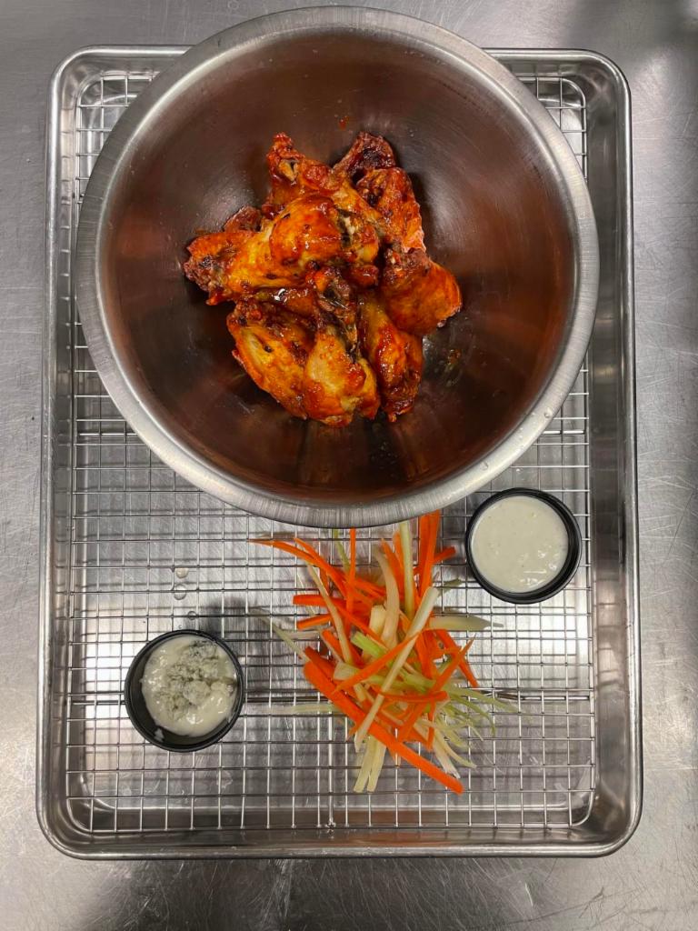 Wings · 6 confit, fried, and then grilled chicken wings tossed in a sauce of your choice. Served with celery, carrots and blue cheese