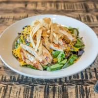 Southwest Chop Salad · Grilled chicken with roasted corn and black bean salsa and cheddar cheese and topped with to...