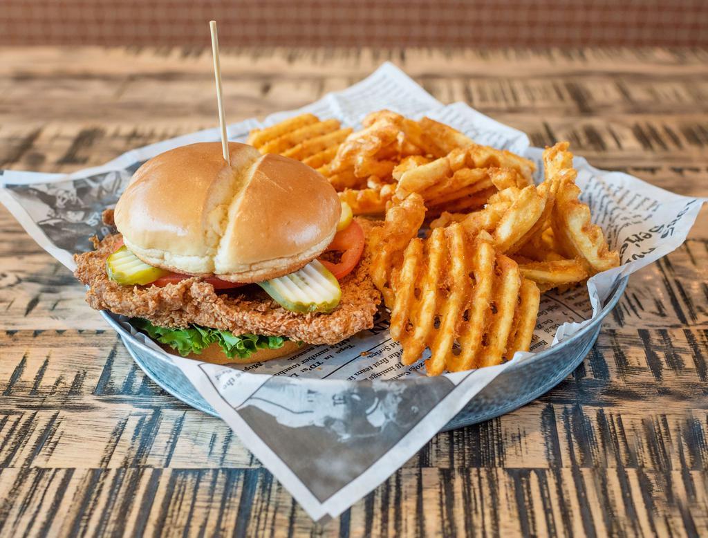 Pork Tenderloin Sandwich · House-pounded and breaded pork loin atop lettuce, tomato and dill pickles with lemon vinaigrette. Served on a toasted brioche bun with a side of mayonnaise.