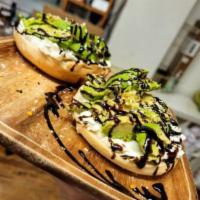 Signature Bagel · Our Instagram-famous bagel with cream cheese, avocado, everything seasoning, red pepper flak...