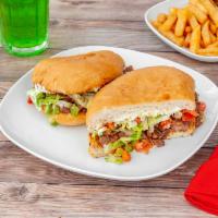 Steak Torta  · Asada. Mexican sandwich served with beans, cheese, lettuce, tomato, and sour cream.