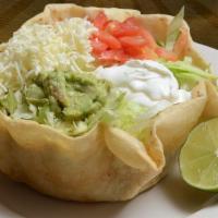 Taco Salad · Crisp flour tortilla shell with choice of ground beef or chicken, lettuce, beans, tomatoes, ...