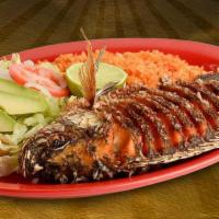 Mojarra Frita · Fried fish served with rice, salad and tortillas.