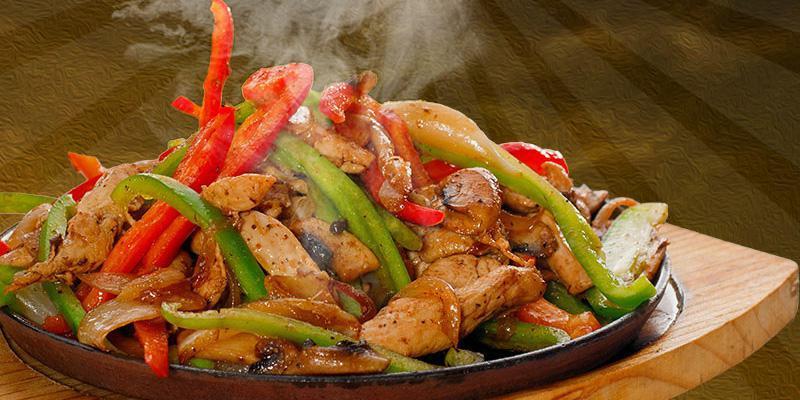 Fajitas · Choice of chicken or steak, sauteed with onions, bell peppers and tomatoes. Served with guacamole salad, sour cream, rice, beans and tortillas.