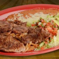 Carne Asada · Rib eye steak with beans, jalapeno and guacamole salad, served with 3 tortillas.