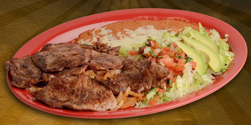 Carne Asada · Rib eye steak with beans, jalapeno and guacamole salad, served with 3 tortillas.