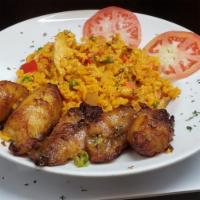 Arroz con Pollo · Rice with sheered chicken, salad, and green or sweet plantain.