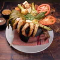 Molcajetes · Burning Aztec stone with special green sauce, slices of tomatoes, Mexican cactus, topped wit...
