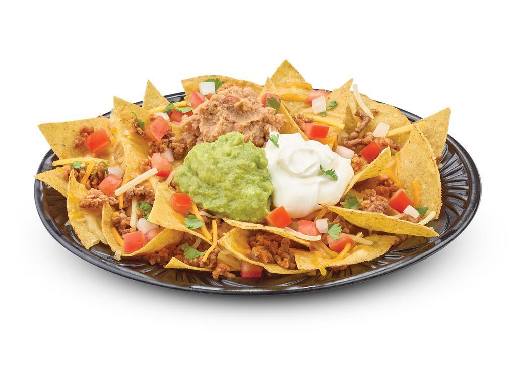 Nachos · Corn tortilla chips topped with cheddar and pepper jack cheese, homemade salsa fresca, refried pinto beans, sour cream, guacamole and your choice of seasoned beef, chicken or pork carnitas.