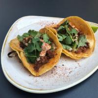 Street Taco Chicken · 2 soft corn tortillas with tender seasoned braised pulled white breast meat, cheese, crema, ...