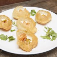 Dahi Aloo Puri · Puffed puri filled with potatoes, yogurt, tamarind and cilantro chutney, topped with sev, ci...