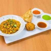 Deconstruted Samosa · Samosa smothered with garbanzo beans curry served with garlic, tamarind and cilantro chutney...