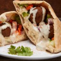 Falafel · Ground garbanzo beans with parsley, cilantro, onions, garlic and seasonings served in a pita...