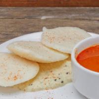 Idli · Steamed rice and lentil cake served with coconut chutney and lentil soup.