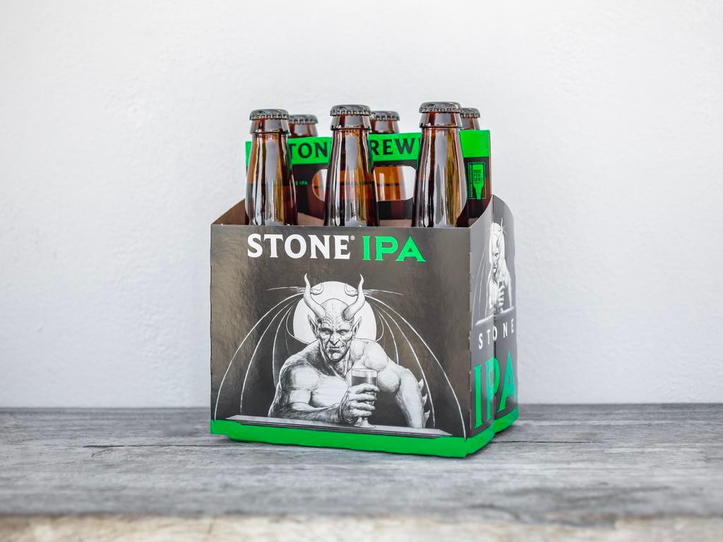 Stone IPA 6Pack · By definition, an India pale ale is hoppier and higher in alcohol than its little brother, pale ale—and we deliver in spades. One of the most well-respected and best-selling IPAs in the country, this golden beauty explodes with tropical, citrusy, piney hop flavors and aromas, all perfectly balanced by a subtle malt character. This crisp, extra hoppy brew is hugely refreshing on a hot day, but will always deliver no matter when you choose to drink it.

TASTING NOTES
FEATURED HOPS
MagnumChinookCentennialAzaccaCalypsoMotuekaElla & Vic Secret™
FLAVOR PROFILE
Citrusy, tropical, piney
PALATE
Medium body with no perceivable sweetness and clean lingering bitterness.
APPEARANCE
Pours clear golden with a white head.
AROMA
Intense lemon rind, fruity cereal, and piney hop flavors. Must be 21 to purchase.
